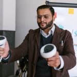 Man in business attire using VR controllers during an office meeting.