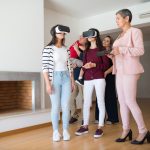 The VR Trap: Why 'More Immersion' Is Killing Your Productivity Family experiencing virtual reality house tour guided by a realtor indoors.